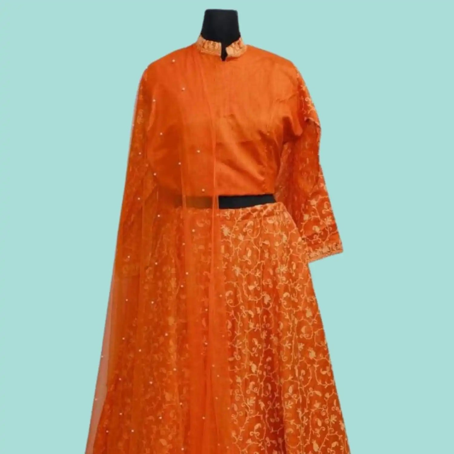 An orange lehenga choli with a matching embellished dupatta.