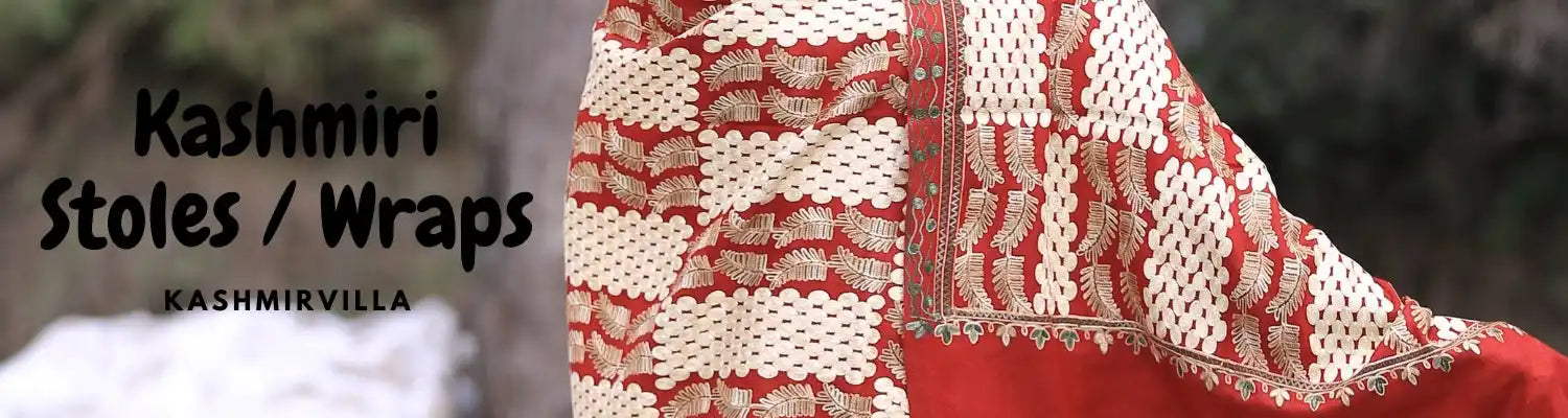 A red and white patterned Kashmiri stole with intricate embroidery.