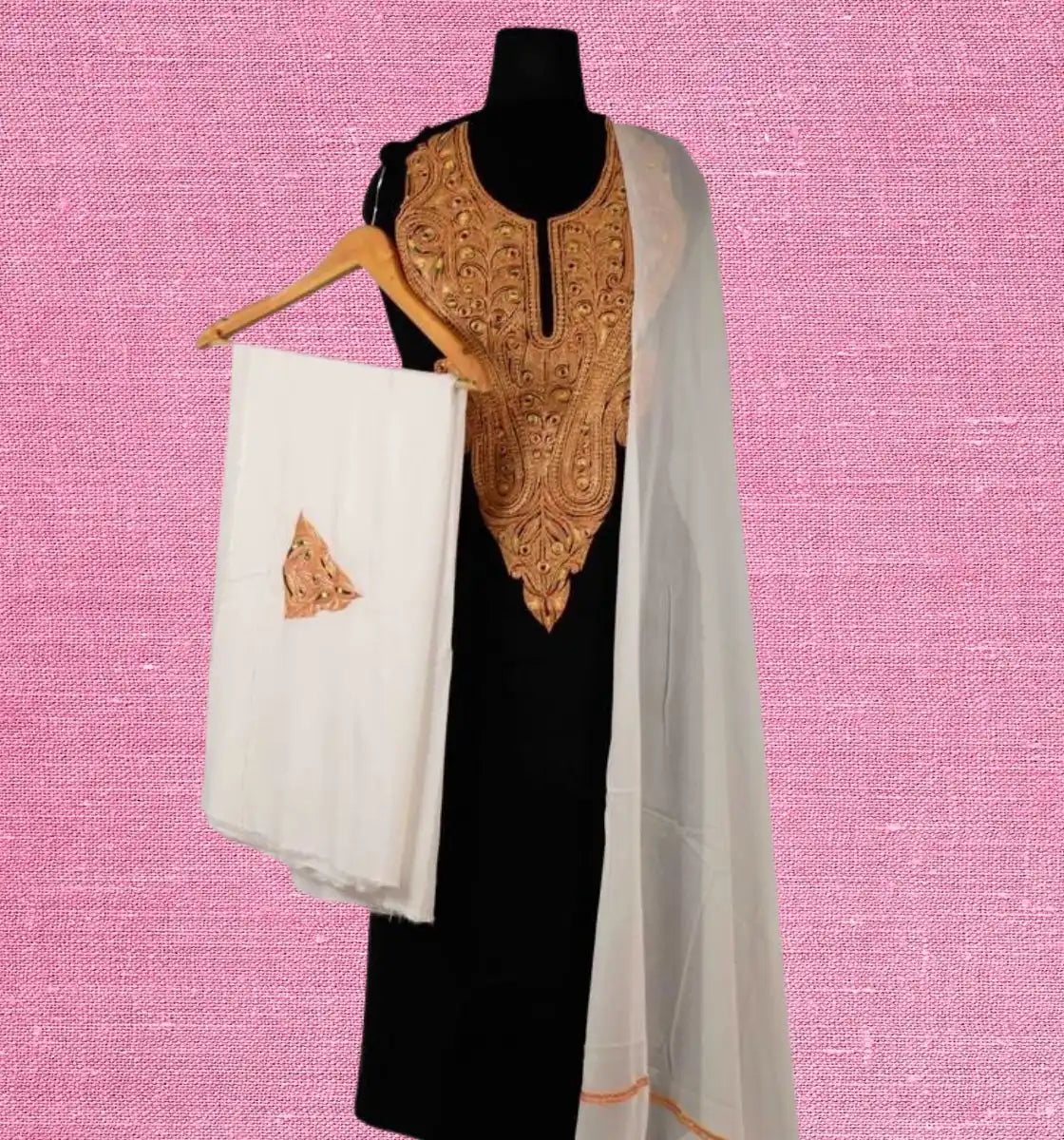 Black salwar kameez with golden embroidery and a white dupatta.