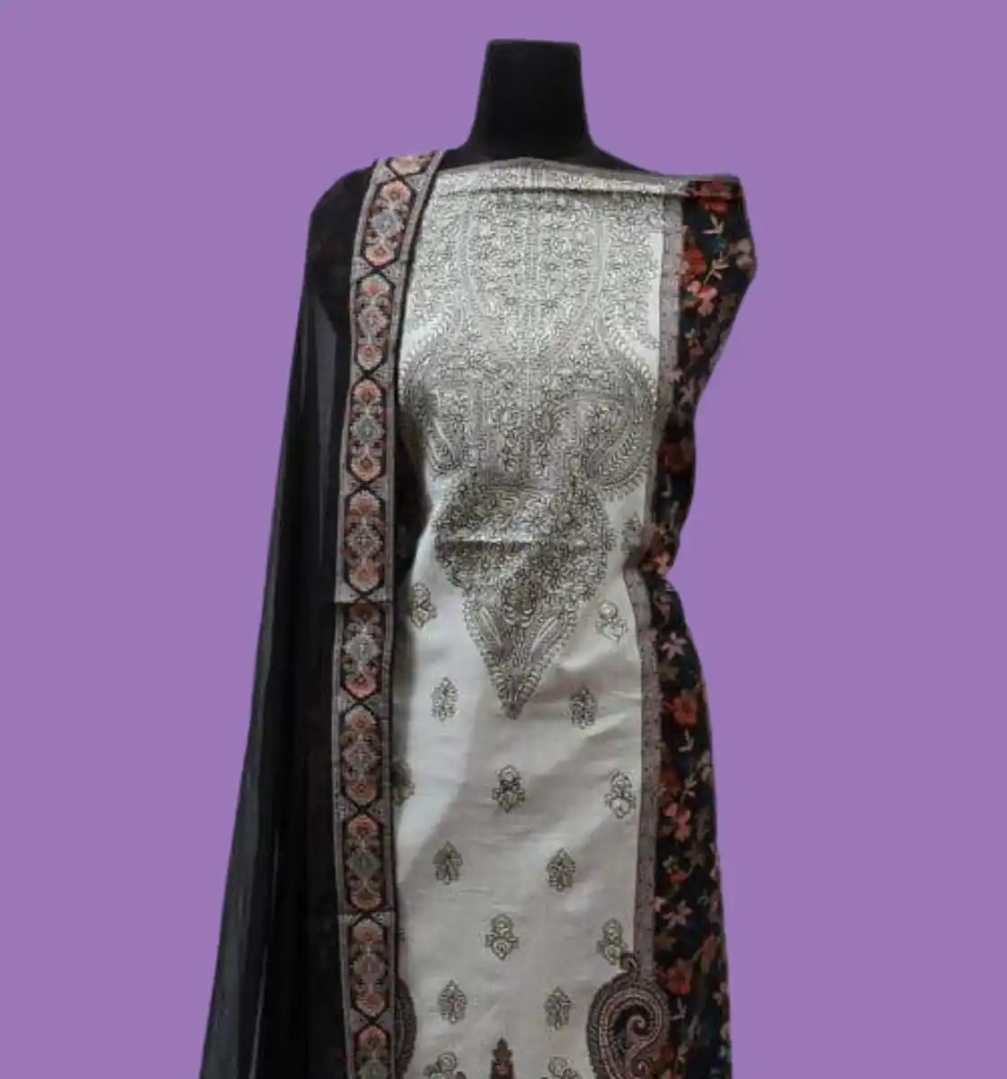 An off-white tunic with intricate black and white embroidery, paired with a black dupatta featuring floral and geometric patterns.