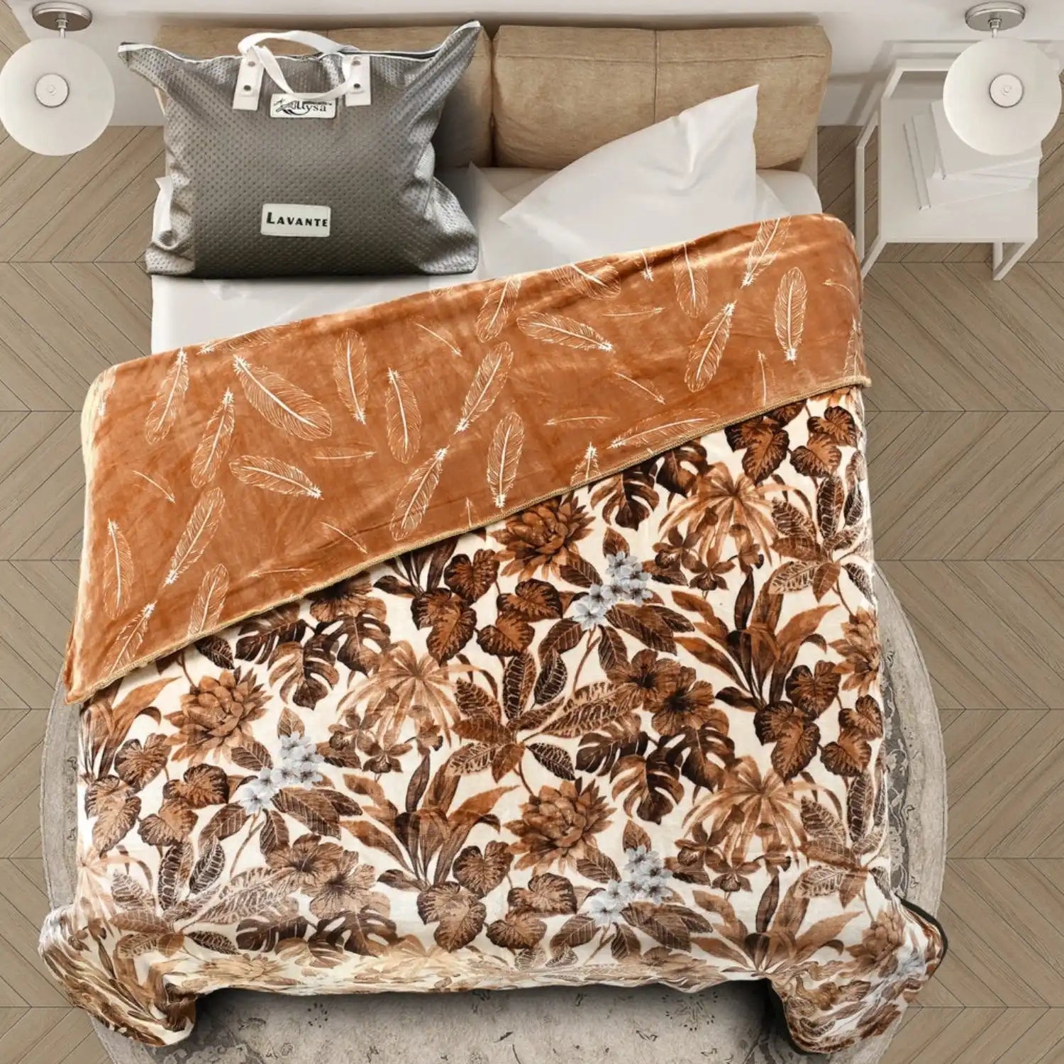 A reversible blanket with a brown feather pattern on one side and a brown and white floral pattern on the other.